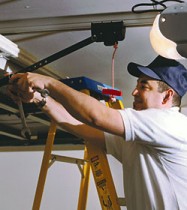 Man fixing a broken garage door spring