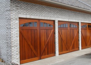 Three Car Garage Doors With Red Wood Double Doors