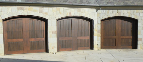 Three Dark Brown Wood Double Garage Doors