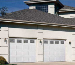 Two Car Garage Doors With Large Cream Stone Columns