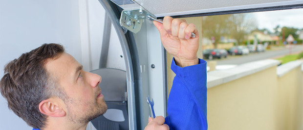 technician-fixing-garage-door Technician Fixing Garage Door