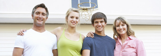 family-in-front-of-garage-door Family Standing In Front Of Garage Door